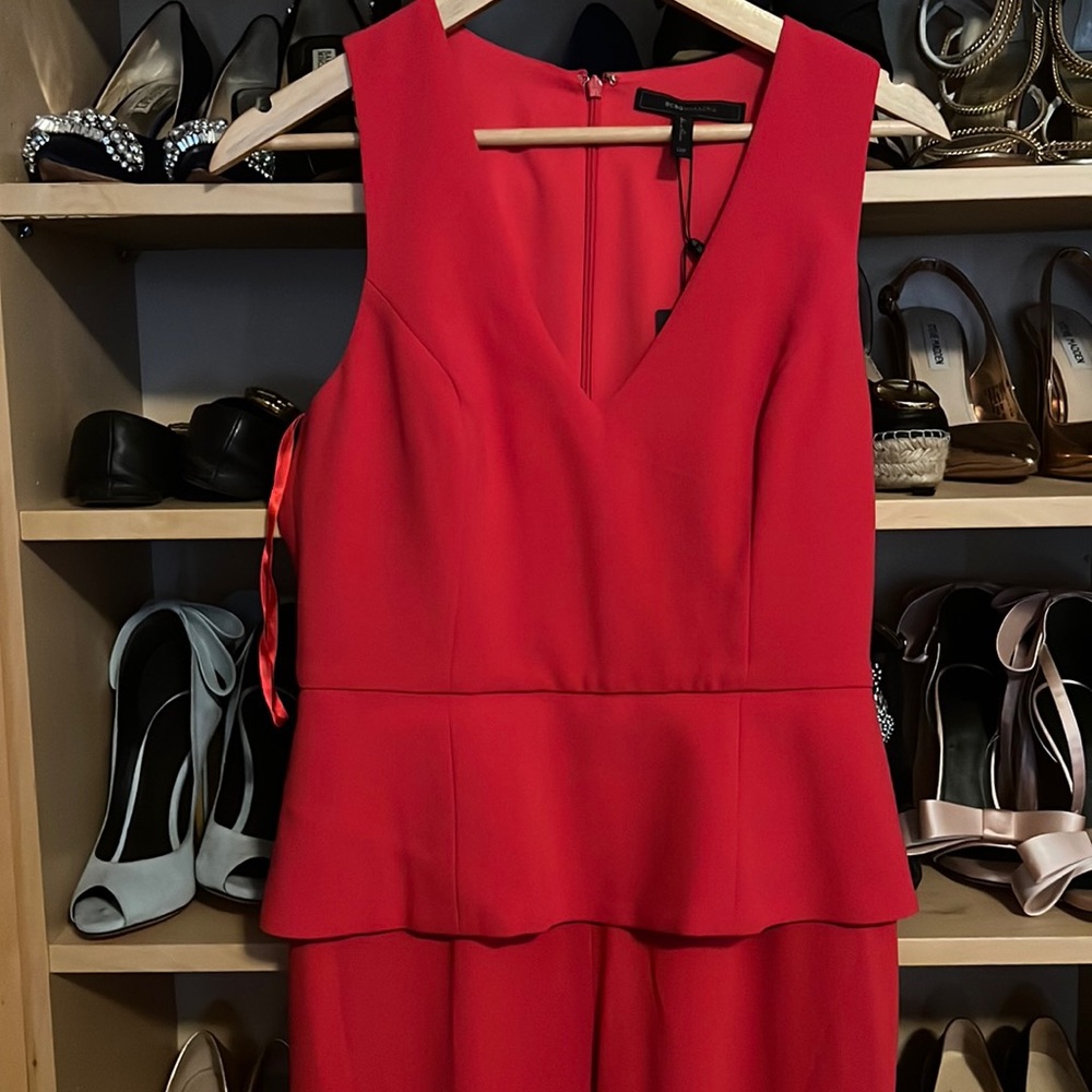 Red jumpsuit with ruffle top. Never worn tag still attached